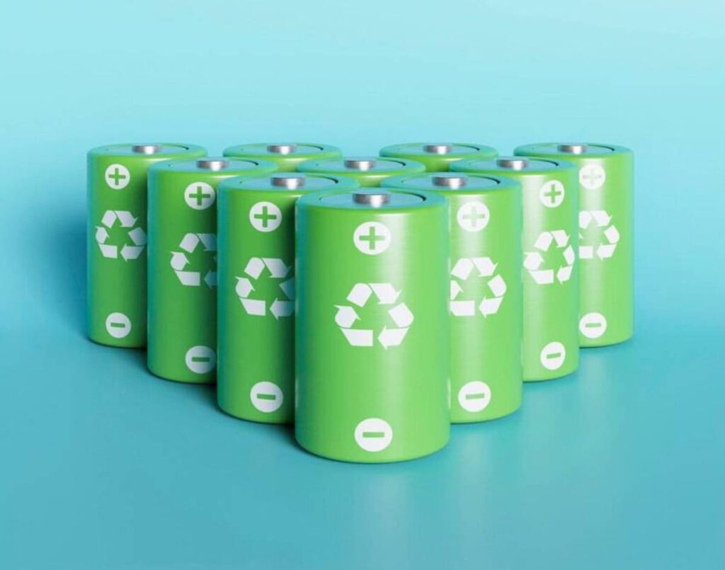 A cluster of green rechargeable batteries with recycling symbols.