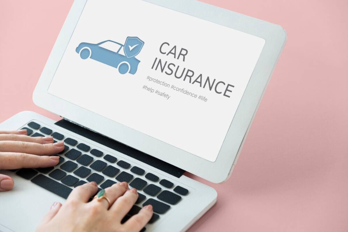   A laptop displaying a car insurance website, with a clear view of policy options and pricing details on the screen. 