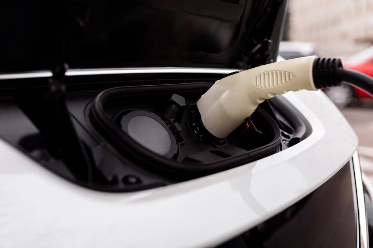   An electric car connected to a charging station, indicating it is being charged for use.
