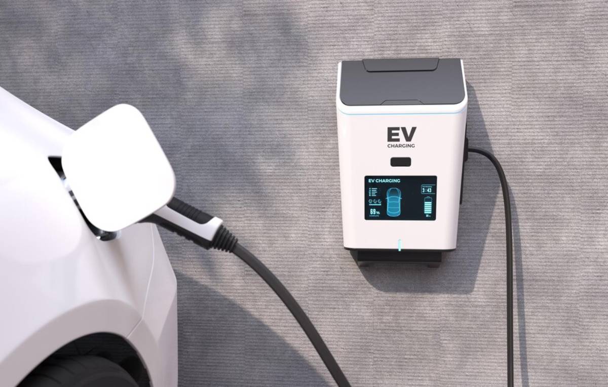  An electric car connected to a charging station, showcasing the process of electric vehicle charging.