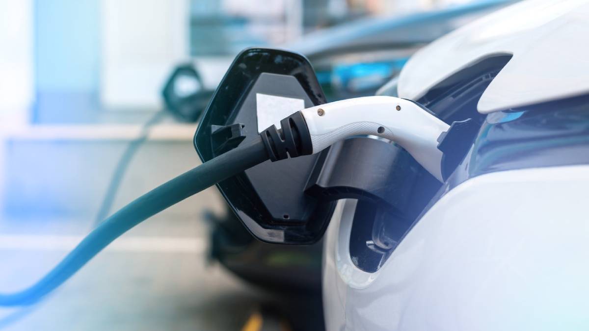 An electric car connected to a charging station, showcasing the process of electric vehicle charging.